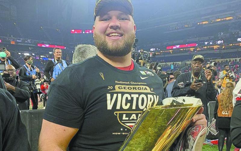 Former Gatewood Gators All-State player Weston Wallace enjoys a moment with the national championship trophy after helping UGA secure its second-straight title-winning season. (Photo/UGA Athletics)