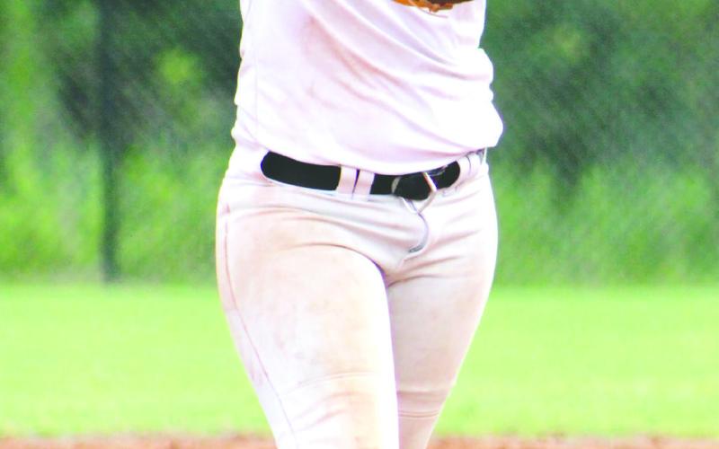 Sam Spisak at first base for the Lady Eagles. Bristol Harris winds up for a pitch against Jasper County.