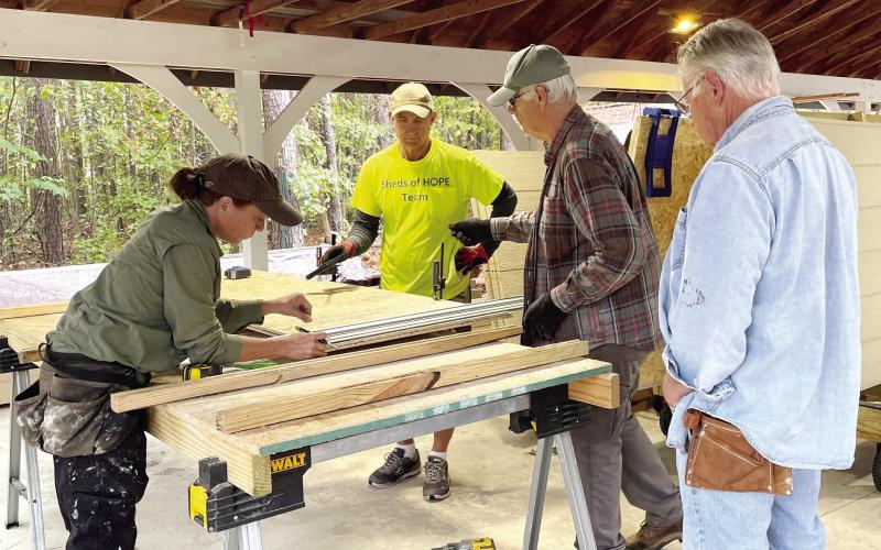 Volunteers prepare the prepackaged sheds that will be distributed to and put together for hurricane victims. T. MICHAEL STONE/Staff
