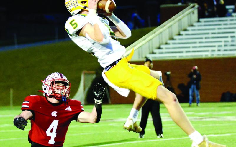 Blake Callaway leaps high in the air to complete just one of at least three outstanding catches he made on the night in the state title game at Mercer. IAN TOCHER/Staff