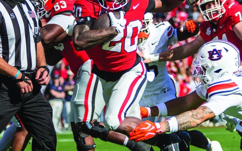 Georgia running back Dwight Phillips Jr. sprints into the end zone for a 7-0 lead against Auburn. SKYLA MORRS/Staff