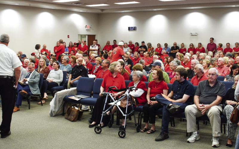 Putnam County Fire Chief Thomas McClain stands beside the podium after he delivered the news that up to 40 citizens attending a Planning &amp;amp; Zoning meeting had to wait outside the large room at the county’s administration building. IAN TOCHER/Staff