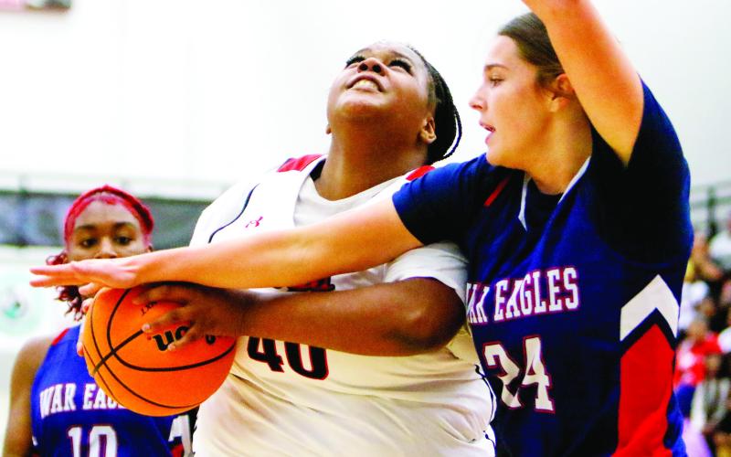 Putnam County’s Kindall Ward (24) tries to prevent Morgan County’s Breniyah Anderson (40) from taking a shot inside the paint. LANCE McCURLEY/Staff