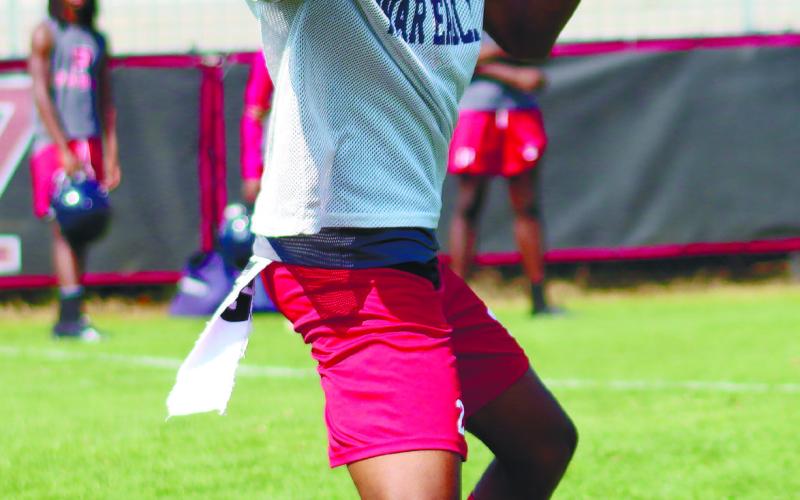 Quarterback Jamarion Robertson drops back for a pass at Morgan County's passing camp last week. LANCE MCCURLEY/Staff