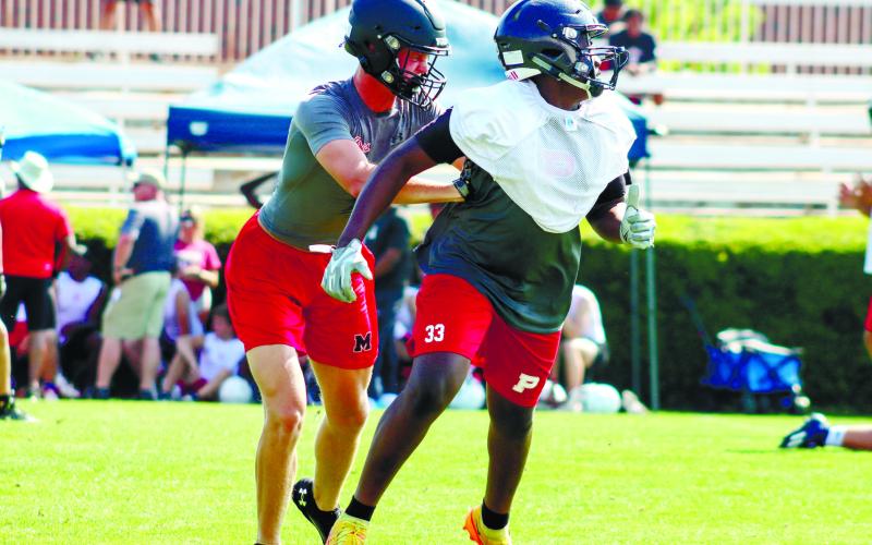 Christian Farley (33) fights off a Bulldog defender while running a route. LANCE MCCURLEY/Staff