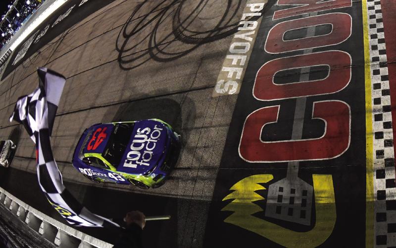 Erik Jones, driver of the #43 FOCUSfactor Chevrolet, takes the checkered flag to win the Cup Series Cook Out Southern 500 at Darlington Sunday. Jones became the first nonplayoff driver to win the first postseason event since NASCAR introduced the elimination format in 2014. (Logan Riely/Getty Images)