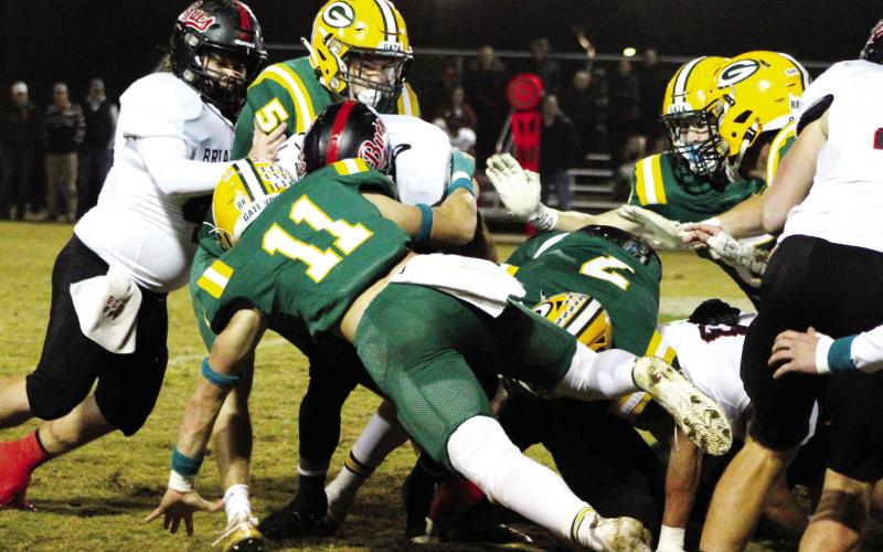 Mason Sinclair (11) makes the stop on a Briarwood ball carrier, aided by seniors Blake Callaway (5) and Evan Bennett (7). ARELLA CASH/Staff