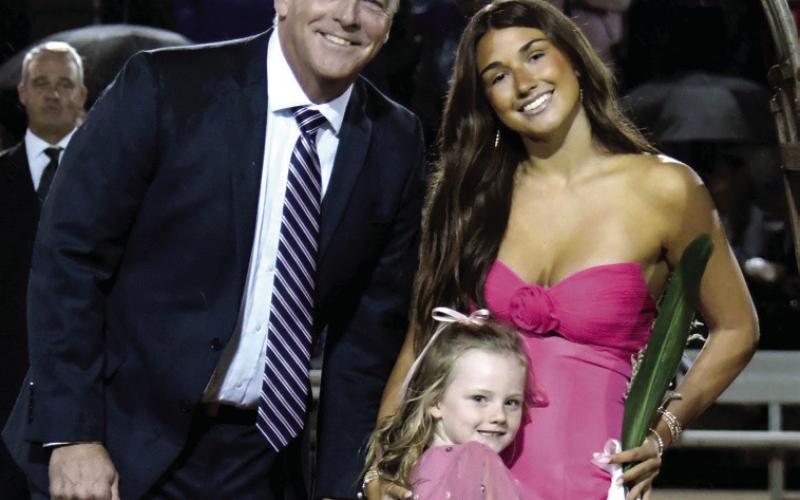 Lauren Paxon, daughter of Gary and Jocelyn Trott, was escorted by her stepdad and K-5 buddy Charlee Brown.