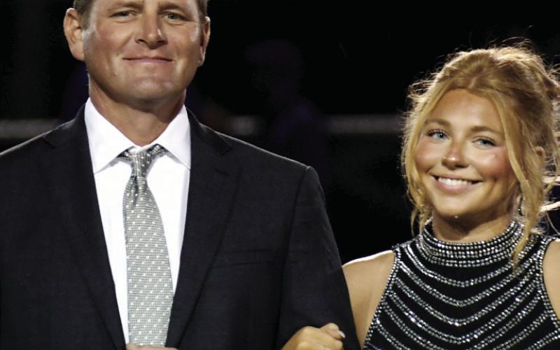 On behalf of his wife, Chandler, Andrew Craine escorted his daughter, Harper.