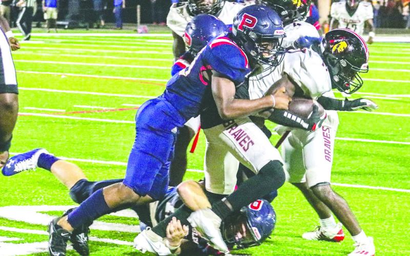 A Putnam County tackler brings down Baldwin wide receiver Armontae Palmer in last year’s game at Al Reaves Field. FILE PHOTO