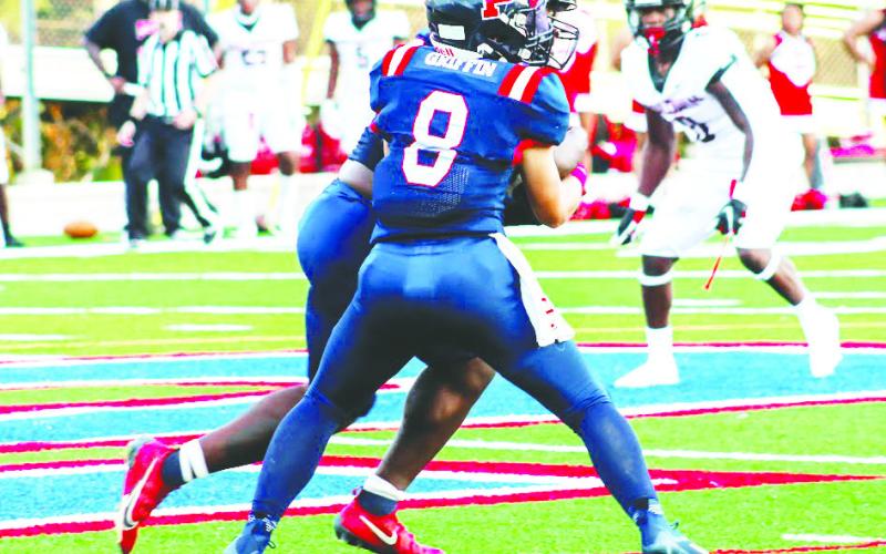 War Eagles’ quarterback Branan Griffin (8) hands the ball off to former running back Tamarion Peters in a 23-14 win. FILE PHOTO