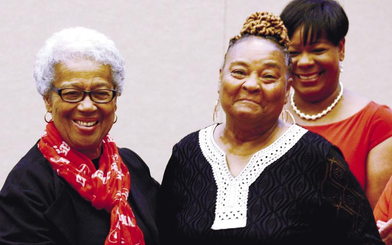 Mothers Against Crime member Brenda Bonner (right), who has been volunteering with the organization since its 1992 inception, received a special service award Saturday night from MAC founder and organizer Georgia Benjamin-Smith. IAN TOCHER/Staff