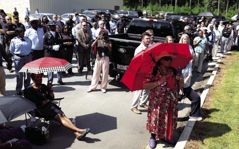 Estimates of up to 200 people endured sweltering conditions to pay tribute to Sgts. Monica and Billue in the Dollar General parking lot alongside Hwy. 16, not far from where both corrections officers were killed in the line of duty.