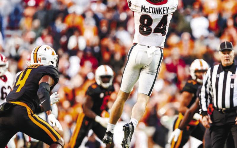 Wide receiver Ladd McConkey (84) goes up and makes a catch between multiple Tennessee defenders in last year’s game against the Volunteers. TONY WALSH/UGA Athletics