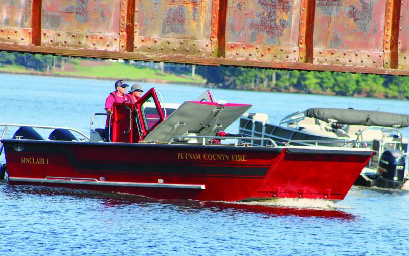 Putnam County Fire Department’s personnel scan the lake from “Sinclair 1” searching Lake Sinclair with other agencies for the missing jet ski rider. LYNN HOBBS/Staff