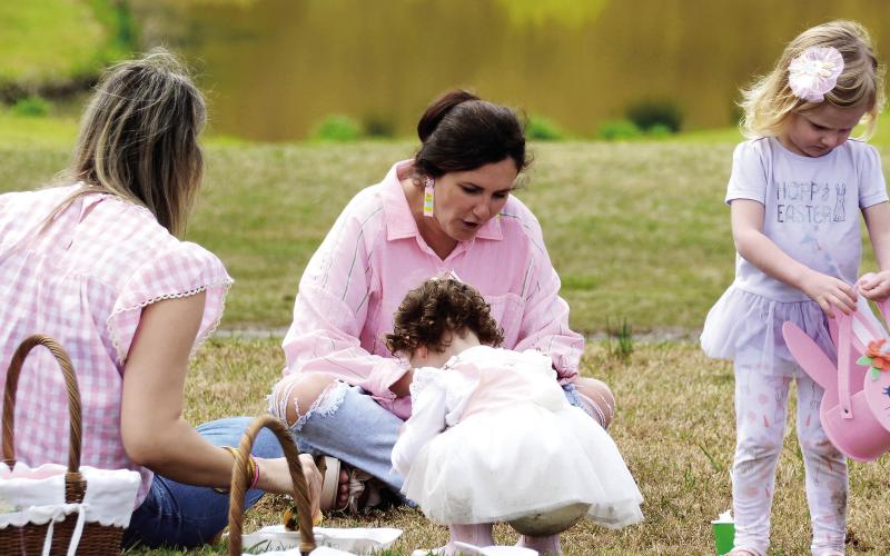 Pretty in pink. One of the Uncle Remus Golf Course ponds provided a perfect Easter backdrop for a family gathering during Saturday’s inaugural Leadership Putnam Easter Egg Hunt. IAN TOCHER/Staff