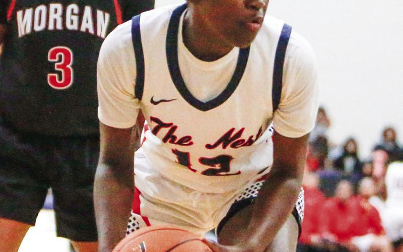 Putnam County junior guard Eriyana Little (12) looks to make a pass after grabbing a rebound in a win over Morgan County on Nov. 22. LANCE McCURLEY/Staff