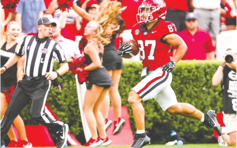 Mekhi Mews (87) breaks away from Ball State defenders during a 69-yard punt return, which sparked the Bulldogs to score 45 unanswered points. TONY WALSH/UGA Athletics