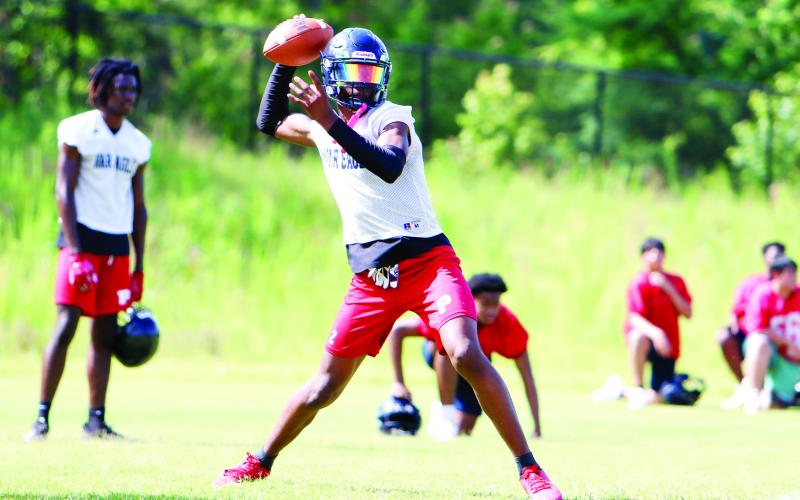 Putnam County senior quarterback Jamarion Roberton sits in the pocket, preparing to fire a pass across the field during Tuesday’s practice. (LANCE MCCURLEY/Staff)