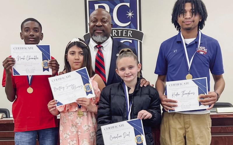 L-R: Students Noah Chamblee, Brittany Suazo Alvarez, Caroline Dial, and Kaden Thompkins received February Student of the Month certificates and swag bags from Putnam County School Superintendent Derick Austin. IAN TOCHER/Staff
