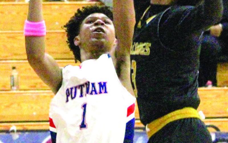 Putnam County freshman Jeremy Banks (1) goes up for rebound against Thomson guard in last Tuesday’s loss to the No. 1 Bulldogs. TREY NORRIS/Staff