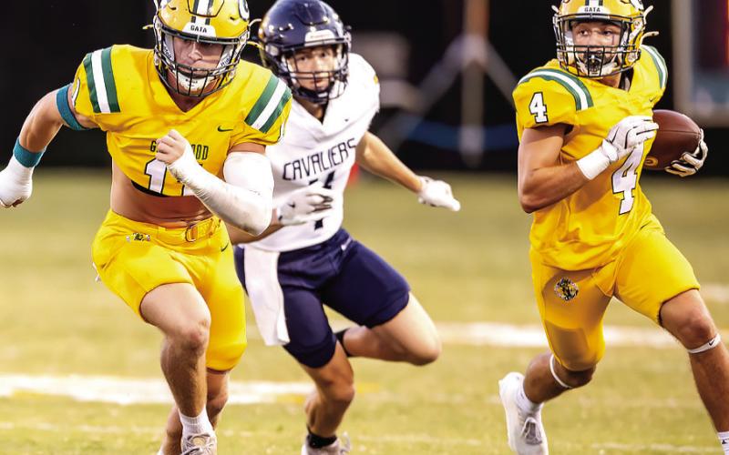 Gatewood senior linebacker Mason Sinclair (left) helps clear a path for junior running back Landon Moreno on one of many carries he had, including two touchdown runs in a 13-10 win Friday night in Eatonton. CONTRIBUTED
