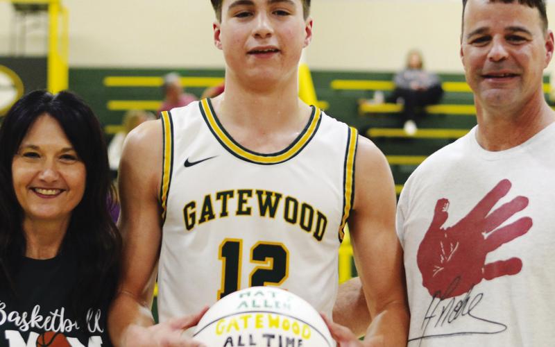 Matt Allen posed with his parents, April and Mark Allen, last Saturday after scoring his 1,665th point to become the all-time top scorer for Gatewood. IAN TOCHER/Staff