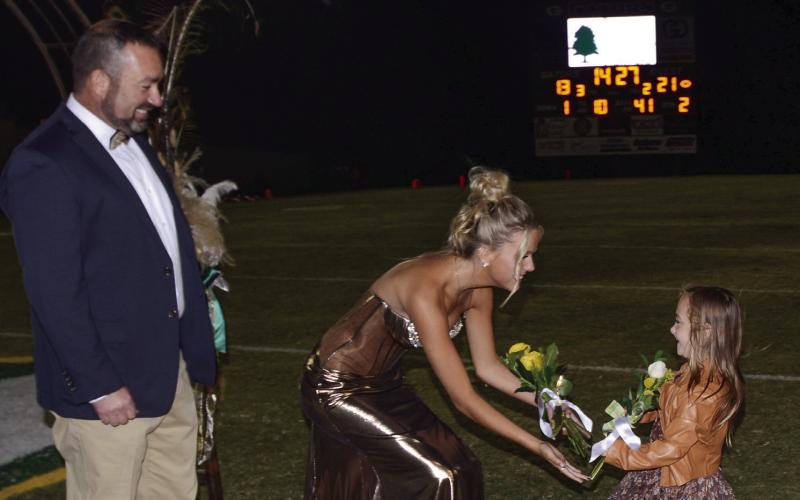 With her father Aaron Burgess looking on senior Kenadee Erin Burgess is presented with a floral bouquet by Ella Tuck. IAN TOCHER/Staff