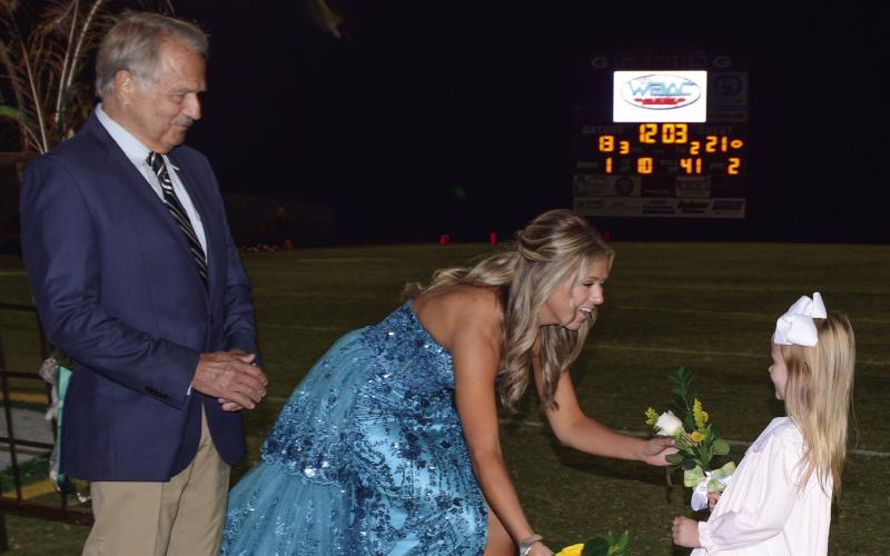 Charles Eiesle watches as his daughter Sophia Linden Eiesle receives her Homecoming bouquet from K-5 buddy Emma Fletcher, filling in for Charlotte Culp, who was unable to attend. IAN TOCHER/Staff