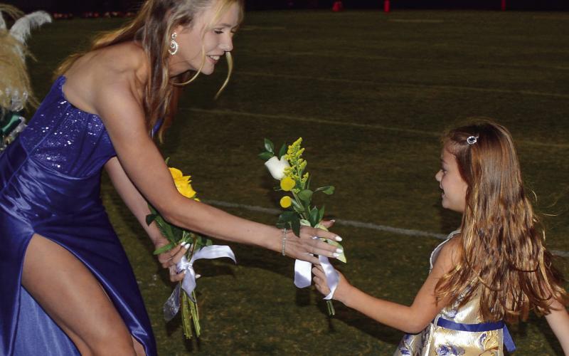 After being presented by her grandfather Bob Weaver, Ansleigh Noelani Hillin accepts her flowers from K-5 buddy Lane Acker. IAN TOCHER/Staff