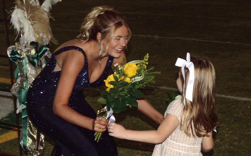 Hannah Marie Lowery, escorted by her father Clay Lowery, receives a bouquet from K-5 buddy Ruth Wilson. IAN TOCHER/Staff