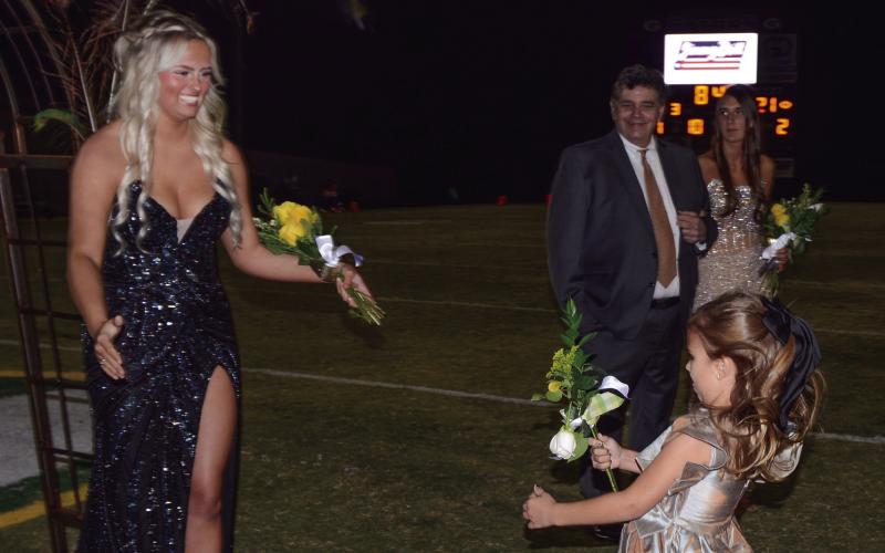 K-5 buddy Pruitt Womack delivers a floral bouquet to Abbie Grace Mixion, who was escorted by her father Mike Mixion.
