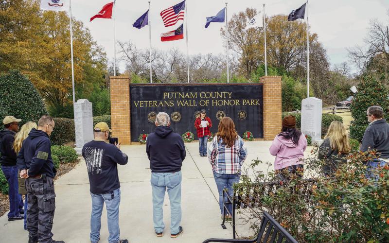 Standing in front of the Putnam County Veterans Wall of Honor, VFW Commander Nikki Barker addressed a small but dedicated group of volunteers on Wreaths Across America Day last Saturday. JOHN BETANCOURT/Contributed