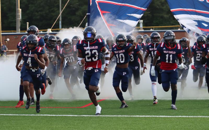 DJ Bland (4), Jalon Kilgore (23) and Tyson Waller (11) lead the War Eagles onto the field. ARELLA CASH/Staff
