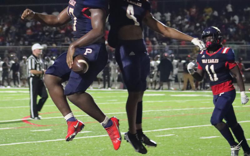 Peters (27) and Bland (4) celebrate following the fourth quarter touchdown. ARELLA CASH/Staff