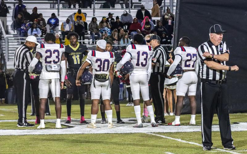 Jalon Kilgore (23), Kemarion Griffin (30), Mark Little (13) and Tamarion Peters (27) act as captains for Putnam County and meet at midfield with players from Thomson. LANCE MCCURLEY/Staff