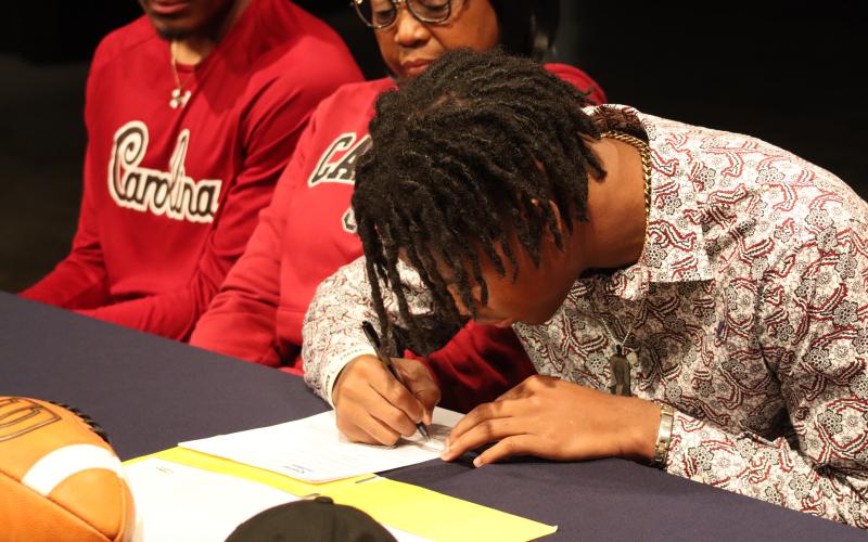 Kilgore signs his letter of intent in front of friends, family and peers. BRENDAN KOERNER/Staff