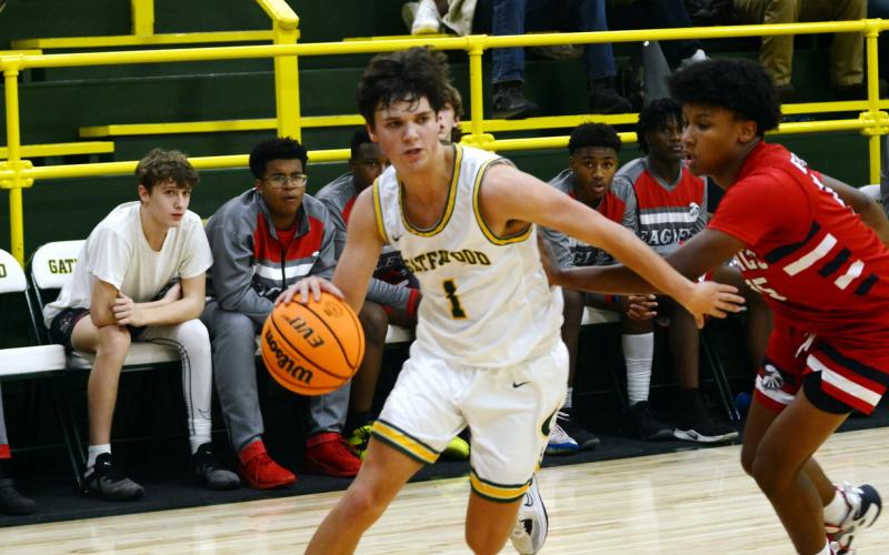 Gatewood senior Jackson Morris (1) drives the lane against a defender earlier this season. IAN TOCHER/Staff