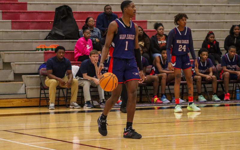 Putnam County point guard Eren Banks (1) brings the ball up the court against Northside-Columbus in a game earlier this season. LANCE MCCURLEY/Staff