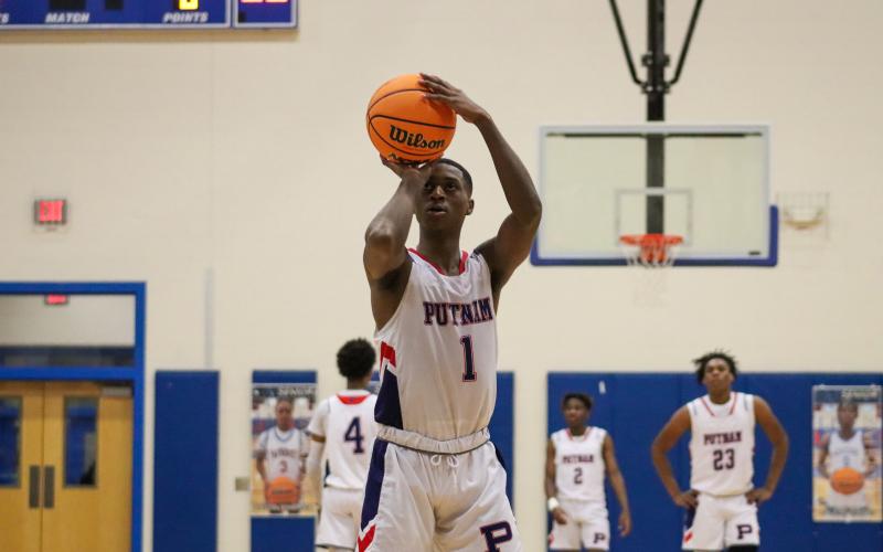 Putnam County senior Eren Banks (1) lines up a free throw shot in a win over Butler last week in the Region 4-AA semifinals. LANCE MCCURLEY/Staff