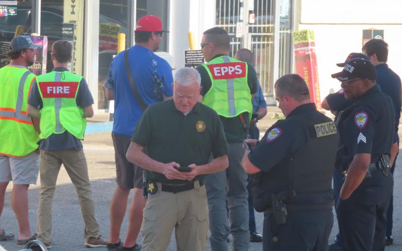Eatonton police officers, fire department personnel and Putnam County Sheriff's deputies at the Shell Food Mart on Sumter Street where a shooting happened Sunday. (Contributed photo)