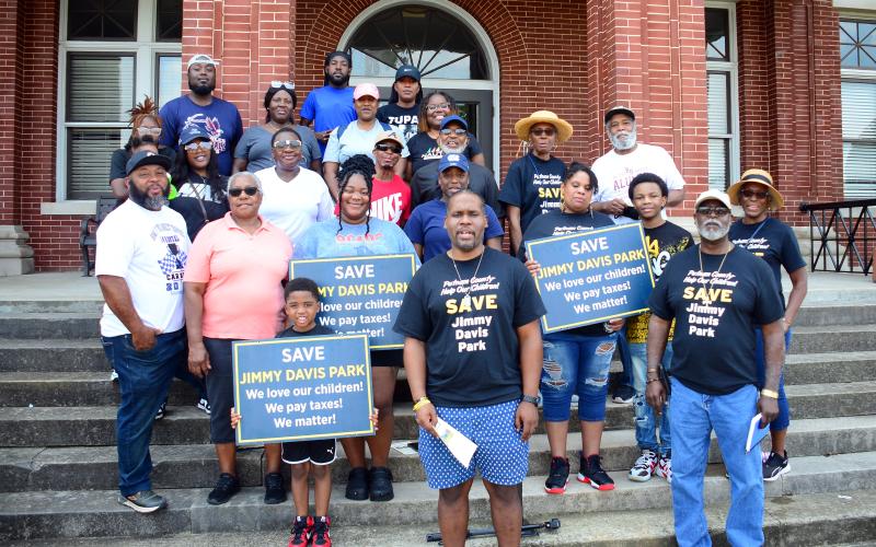 NAACP President Gerald Griggs (front, center) is surrounded by members of Jimmy Davis’ close and extended family on the front steps of the Putnam County Courthouse.