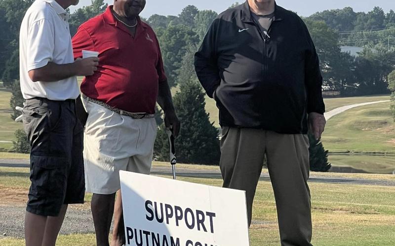 Tight ends' coach Charles Winslette (right) with two golfers. CONTRIBUTED