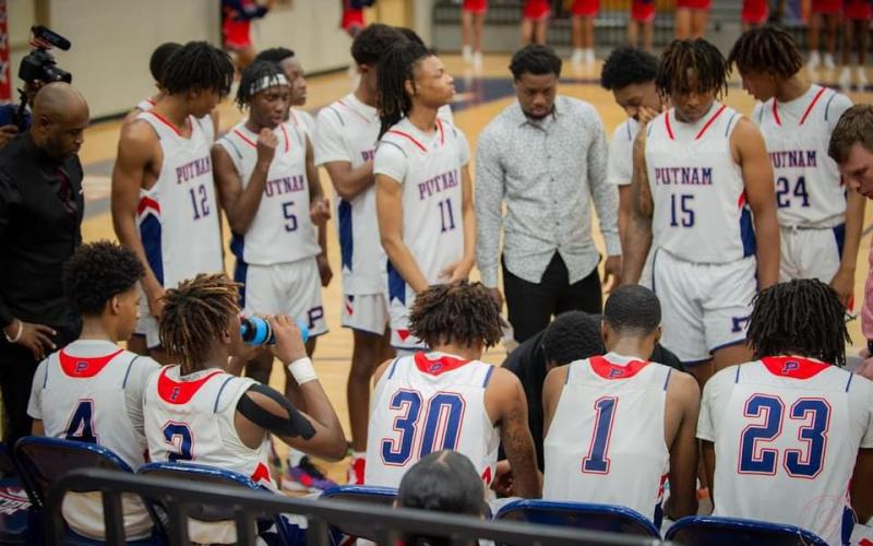 Banks looks on with War Eagles’ players during a timeout as head coach LaPatrick Marshall draws up a play in the huddle. CONTRIBUTED