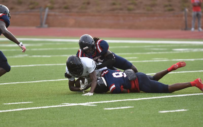 War Eagle defenders Tyson Waller (11) and Kaleb Crawford (9) bring down a Greene County running back. BRENDAN KOERNER/Staff