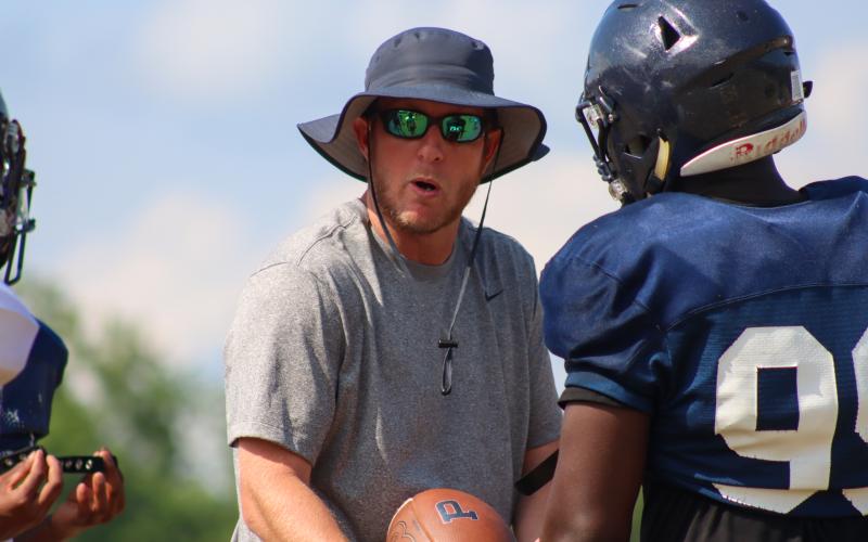 Joel Harvin coaches up a player during spring camp last May. LANCE McCURLEY/Staff