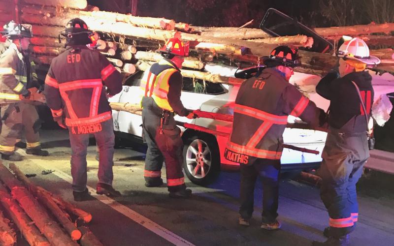 Eatonton Fire Department first responders work to rescue a driver trapped in an SUV after crashing into a log truck Monday. (Contributed by EPD)