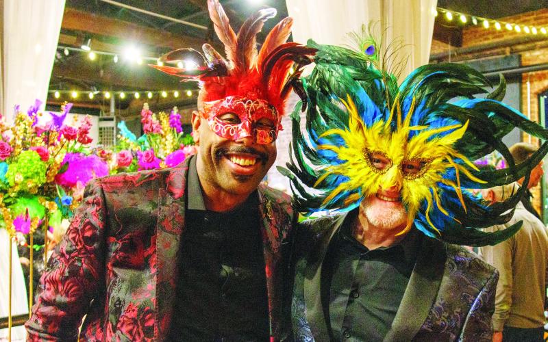 Guests came dressed to impress with festive Mardi Gras masks against a backdrop of colorful decor. 
