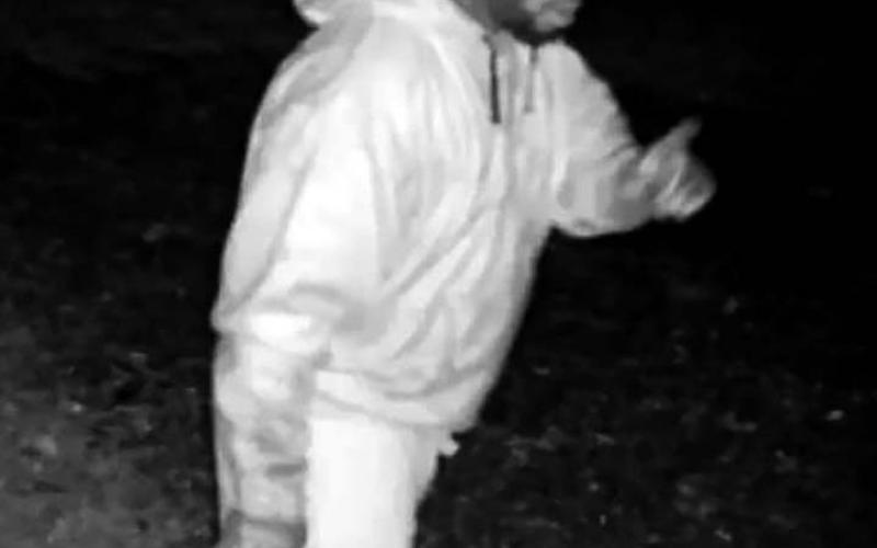 Security camera reveals an armed prowler in the yard of a River Lake Drive residence.