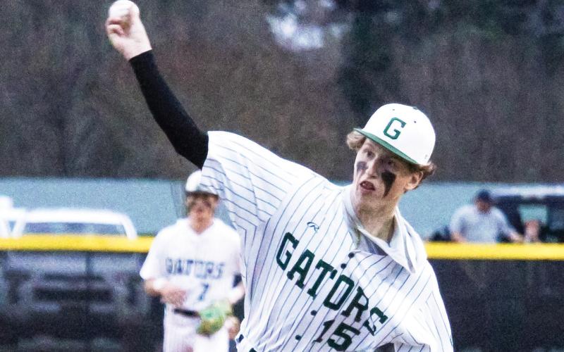 Gatewood senior Lawson Wooten (15) brings the heat last Tuesday in the Gators’ season opener at home against the Westfield Hornets. TREY NORRIS/Staff